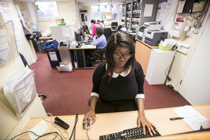 A receptionist at a GPs’ surgery in London. Better communication with patients can yield substantial benefits