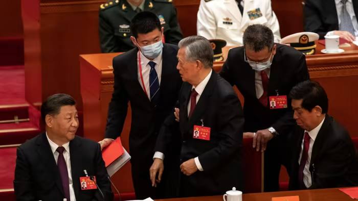 Hu Jintao is escorted out of the closing session of the Chinese Communist party’s congress in Beijing