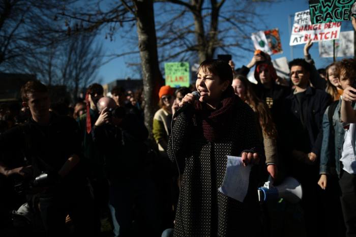 Caroline Lucas of the Green Party speaks at a rally as schoolchildren take part in a student climate march