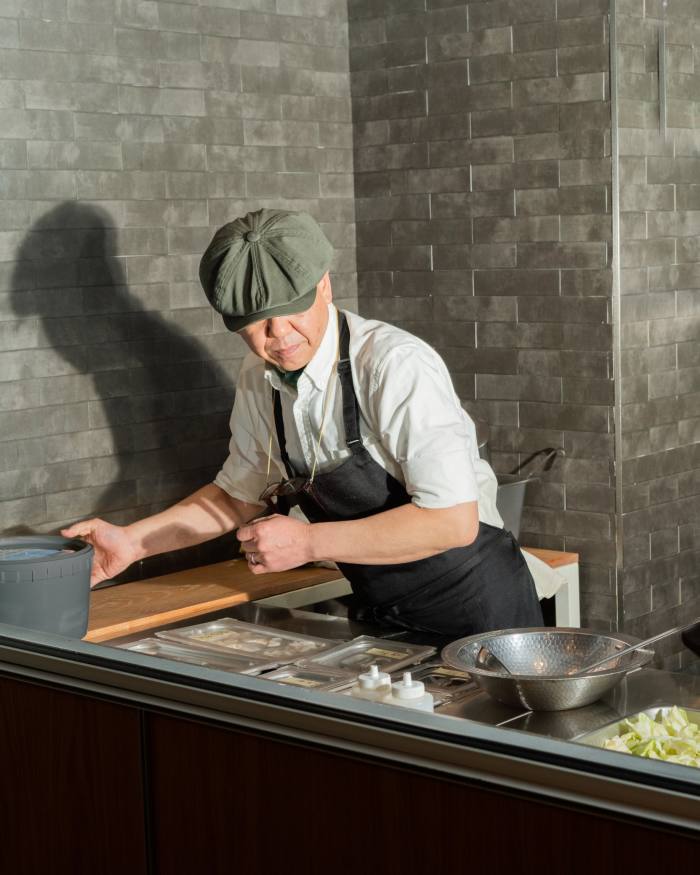 head chef Koji Hagihara at work in the restaurant’s grey-brick-walled kitchen