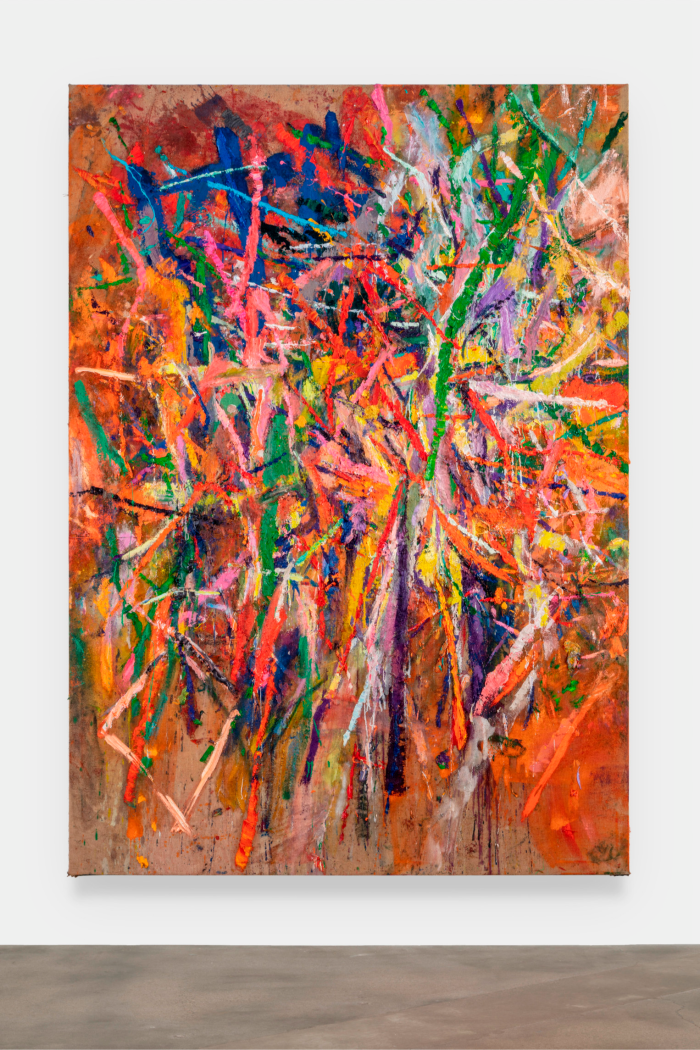 A large modern art painting consisting of lines of green, yellow, red, orange and blue against an orange and brown background