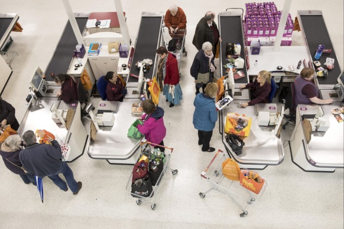 Shoppers purchase groceries at the checkout tills inside a J Sainsbury supermarket 