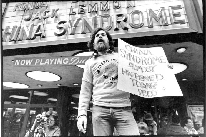 In this black-and-white photo, a bearded man protests in front of a cinema advertising ‘The China Syndrome’. The film came out just weeks before the 1979 accident at Three Mile Island. The protester’s placard reads; ‘China Syndrome Almost Happened Today’