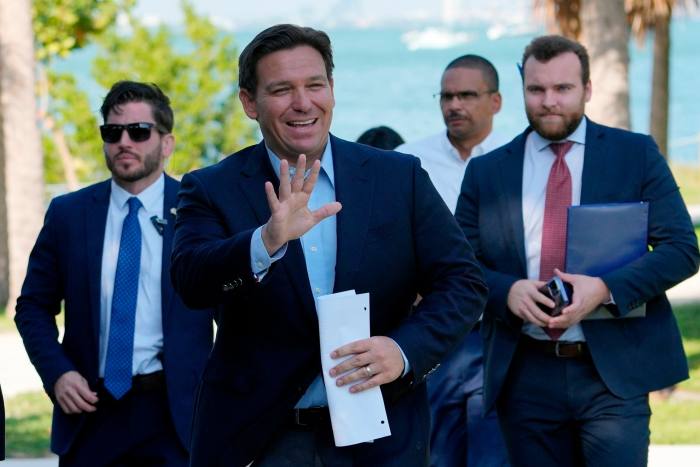 Florida governor Ron DeSantis waves as he arrives for a news conference at Bill Baggs Cape Florida State Park, US