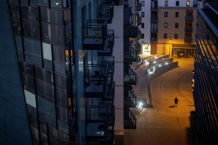 A gloomy street populated by modern office blocks in Leeds