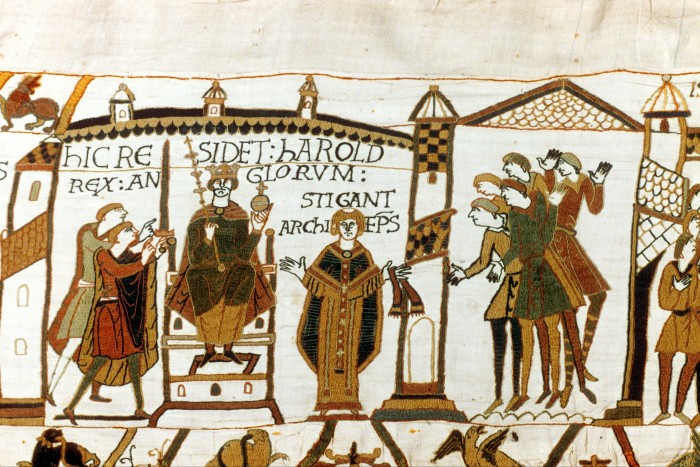 A tapestry featuring Harold II sitting on a throne with a crown on his head