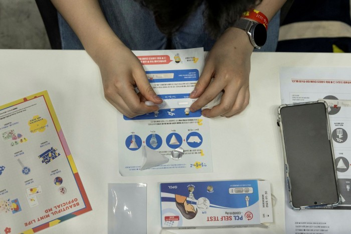 An attendee uses a PCL Inc. Covid-19 rapid self test kit at the Beautiful Mint Life 2021 music festival at the Olympic Park in Seoul, South Korea
