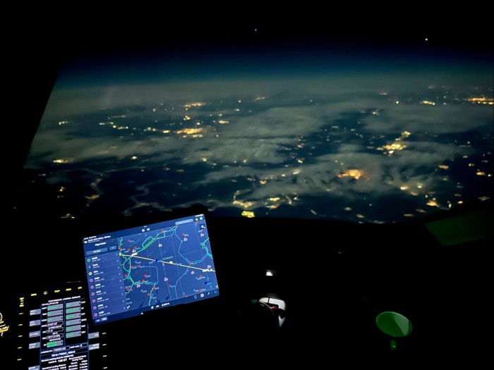 A view from the cockpit at night, with the iPad lit in the foreground