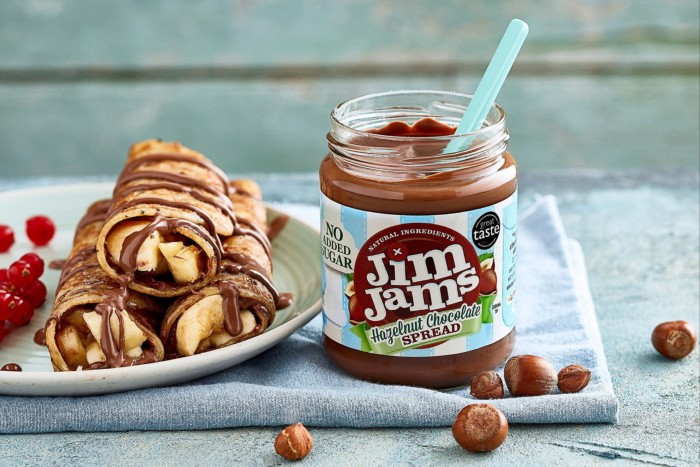 Jim Jams chocolate spread in a jar next to banana pancake rolls drizzled with the sauce