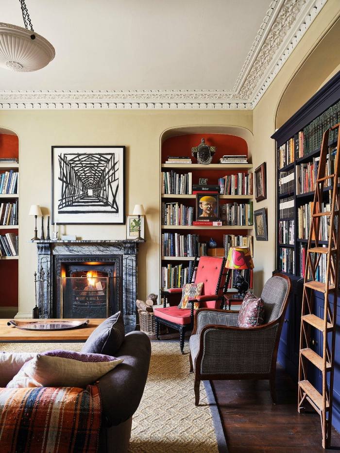Drawing room in the home of Philip Hooper, with a fireplace and books on shelves