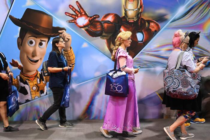 Fans wait in line to visit the D23 Expo Marketplace to buy merchandise during the Walt Disney D23 Expo in Anaheim, California 