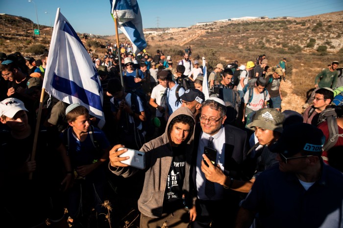 Ben-Gvir poses for a photo as activists try to build a new illegal West Bank outpost near the settlement of Barkan