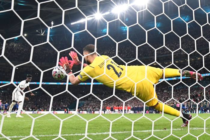 Italy’s goalkeeper Gianluigi Donnarumma saves a penalty taken by England’s Bukayo Saka in the Euro 2020 final at Wembley