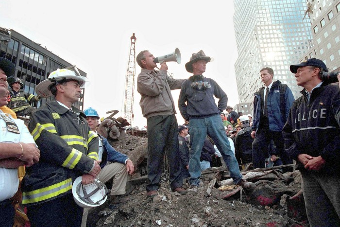 George W Bush speaks to rescue workers, firefighters and police officers from the rubble of Ground Zero on September 14 2001