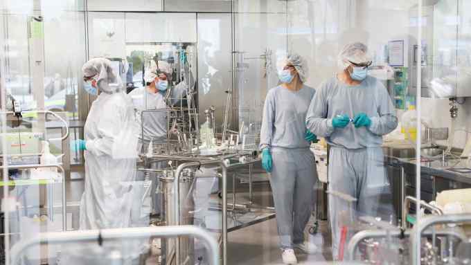 Workers at German drug company Dermapharm, which manufactures Pfizer/BioNTech’s mRNA vaccine against Covid-19