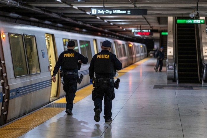 San Francisco Police officers patrol a transit station