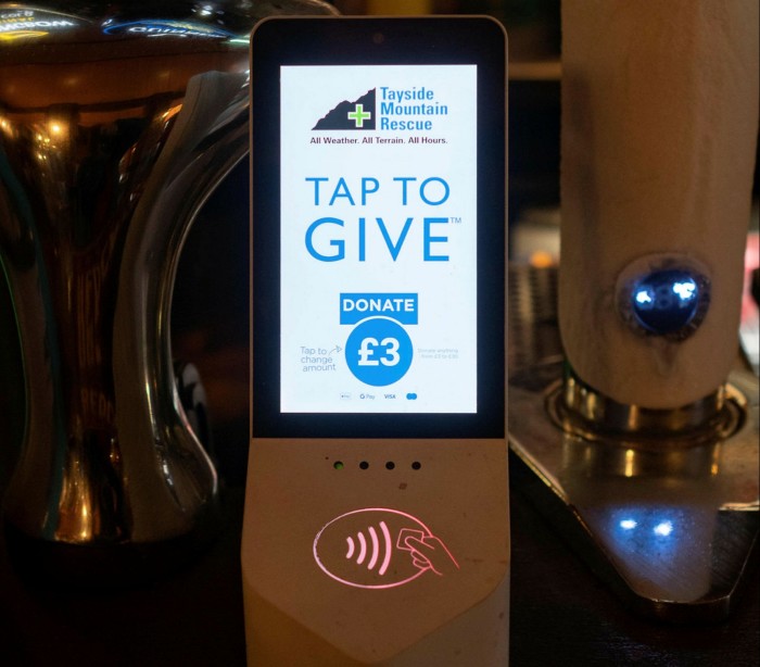 Contactless charity boxes on the bar in a Scottish pub