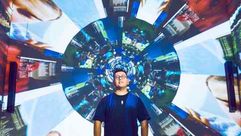 Artist Refik Anadol in front of his AI-driven immersive installation for Bulgari