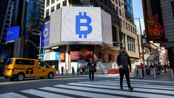 Crypto ETF assets treble as investors take risks Signage of the times: street advertising for bitcoin and Coinbase, the US cryptocurrency exchange that floated in April