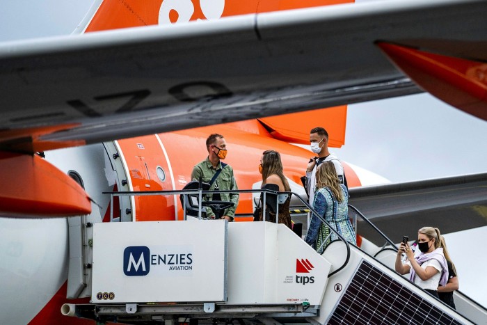 Passengers board an easyJet plane at the Amsterdam-Schiphol airport in the Netherlands