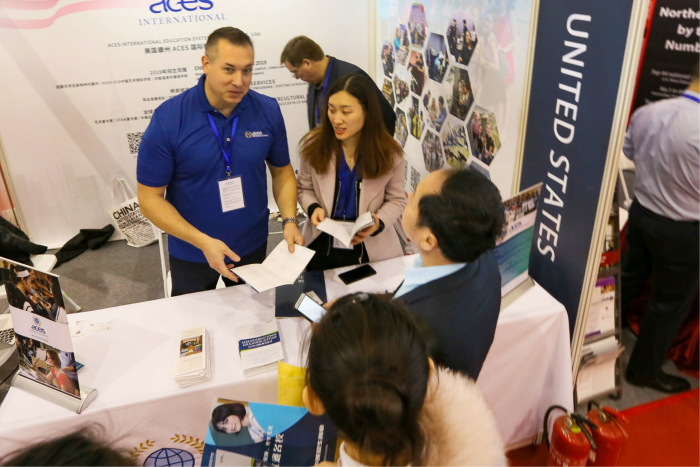 Chinese visitors talk to US education consultants at an expo in Beijing. A decades-long increase in the flow of Chinese students to the US has slowed to a trickle since 2018, with an only 0.8% increase in 2019/20