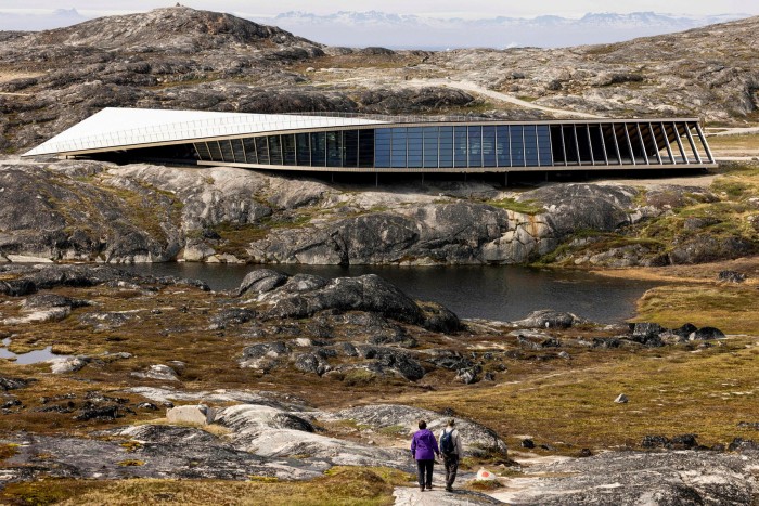 The futuristic Icefjord centre set in a land of rocks and sparse vegetation 