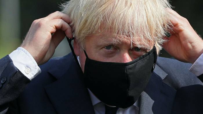 Close up picture of Prime Minister Boris Johnson putting on a face mask. Public opinion is divided as to whether he was genuinely remorseful behind the mask during his ‘partygate’ apology