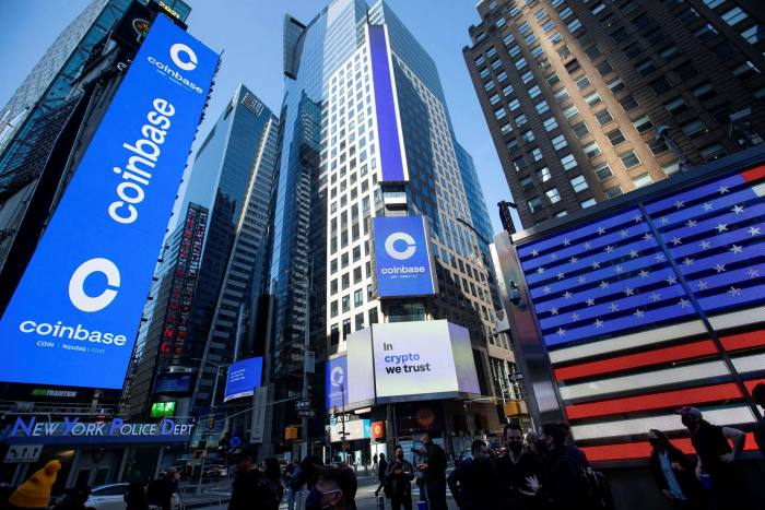 Monitors display Coinbase signage during the company’s initial public offering at the Nasdaq MarketSite in New York