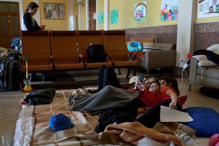 Children lie on a temporary bed at a relief center set up at Lviv's main train station