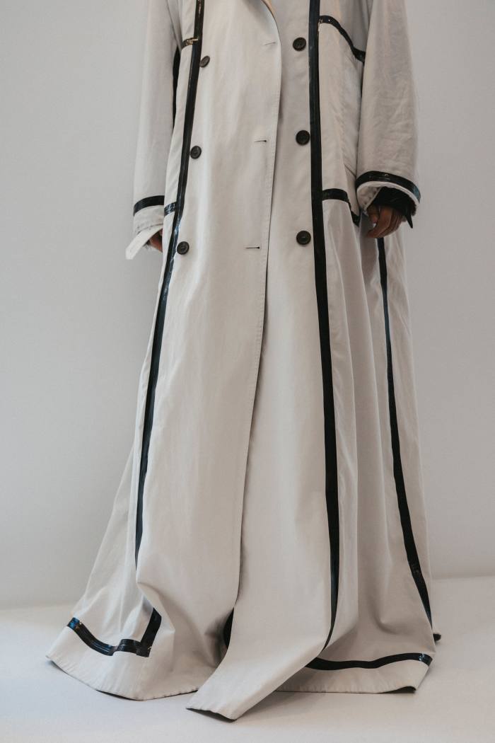Wearing a white reversible duster coat, $3,100