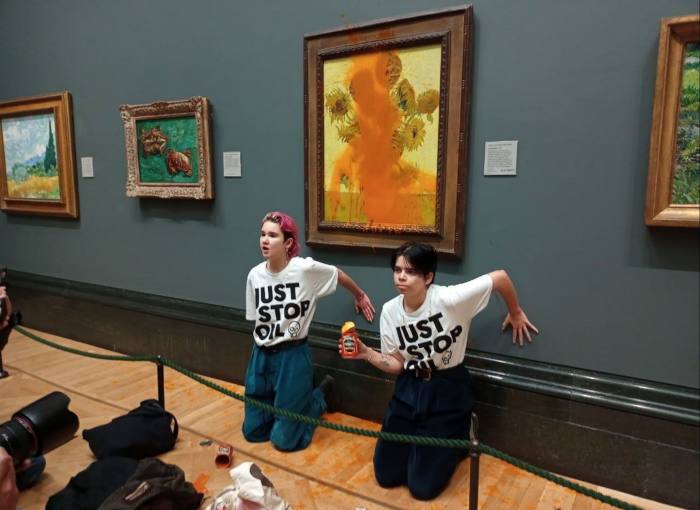 Climate protesters hold a demonstration as they throw cans of tomato soup at Vincent van Gogh’s ‘Sunflowers’ at the National Gallery in London