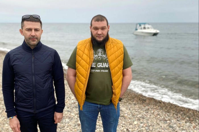 Denis Bukalov (left) with Anton Pirogov, co-founders of the Save Baikal movement, on the shore of the lake in Listvyanka