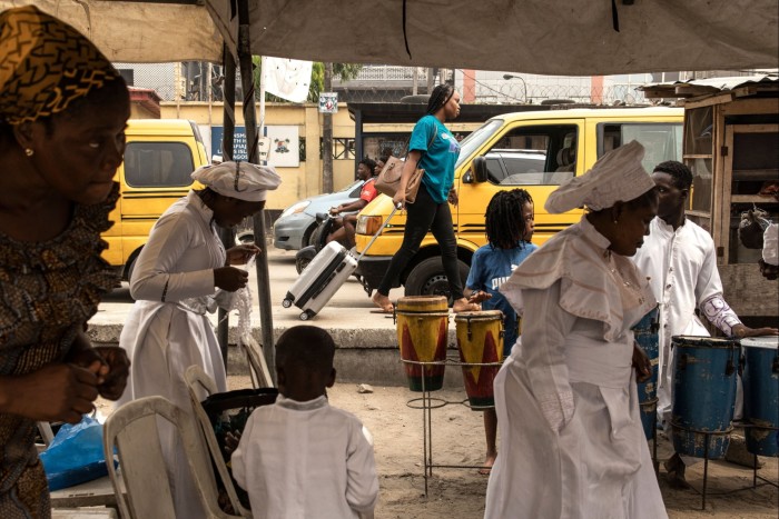 Pedestrians pass a service at the Emmanuel Salem Church in Lagos Island