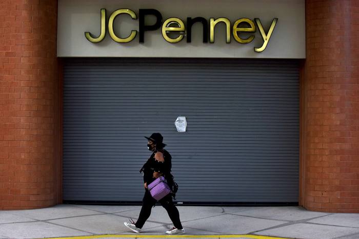 A woman walks by a JC Penney store