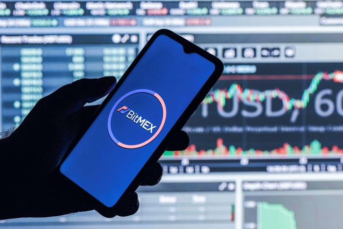 a mobile phone that displays the logo of BitMex, an application for live trading