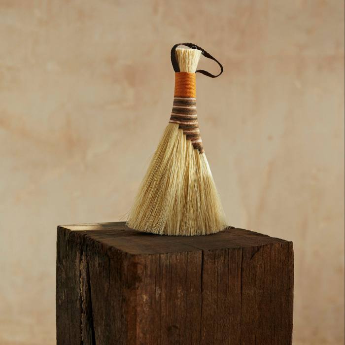 A natural fiber brush on a wooden block