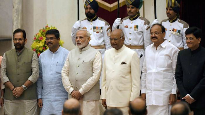 Indian Prime Minister Narendra Modi (third from left), is pictured with members of his government including oil minister Dharmendra Pradhan (second from left) 