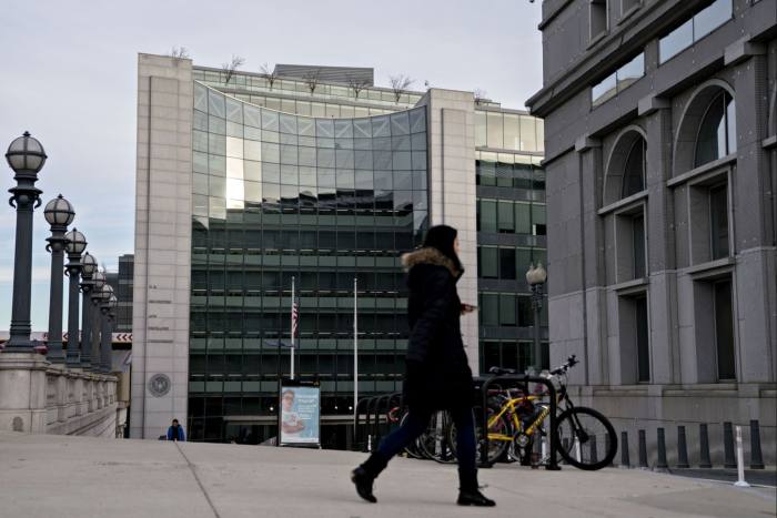 A pedestrian walks near the U.S. Securities and Exchange Commission headquarters in Washington, DC