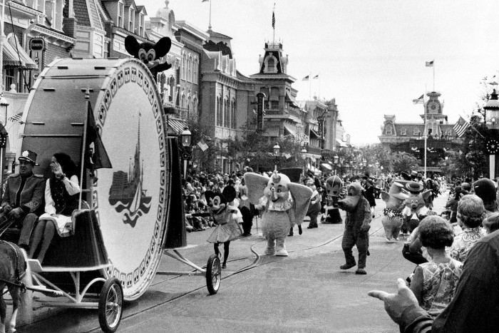 Dumbo and other Walt Disney characters follow a float during a parade at the grand opening of Walt Disney World in 1971