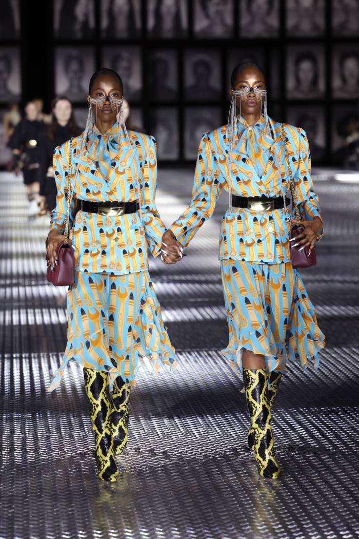 Identical twins on the catwalk in identical patterned outfits