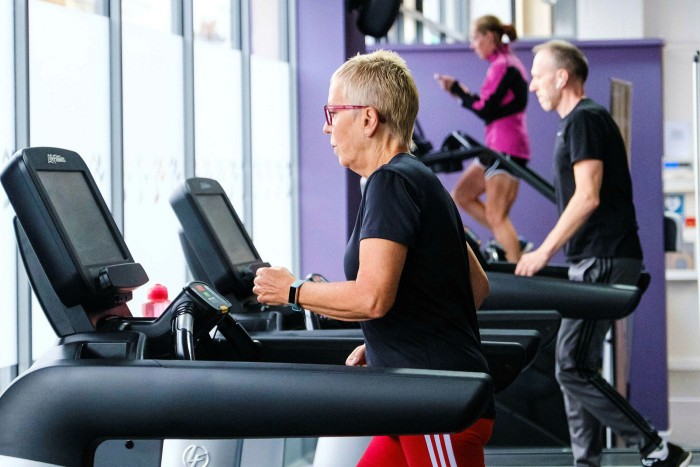 Clients use equipment at an Anytime Fitness gym in Worthing, UK
