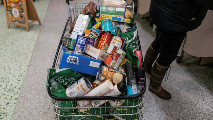 A supermarket shopping trolley filled with goods