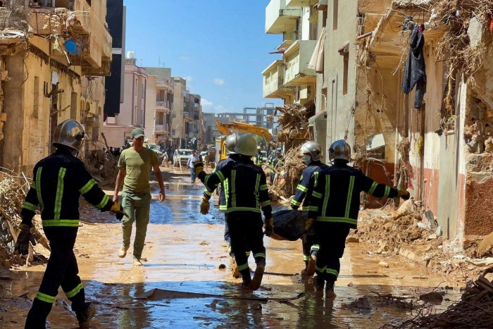 Members of the rescue teams from the Egyptian army walk in the mud between the destroyed buildings: The city centre and two residential districts in Derna have been wiped away