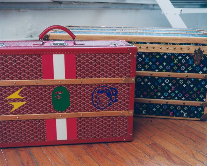 Red Goyard trunk with printed Star Trak, BAPE and Billionaire Boys Club logos, left, and Louis Vuitton monogram steamer trunk