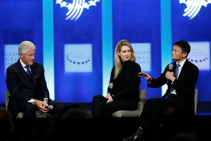 Holmes flanked by former US President Bill Clinton and Alibabab's executive chairman Jack Ma