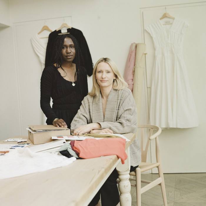 Camille Perry, wearing black, and Holly Wright, wearing light brown/dark cream