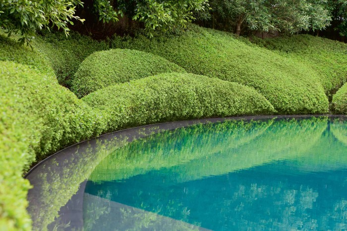 The crescent-shaped basalt pool in a garden in Kohimarama Beach, New Zealand