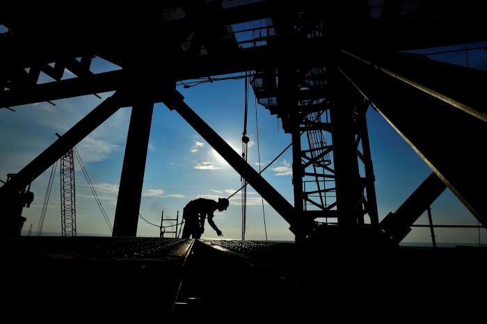A worker is silhouetted at the construction site of the new oil refinery Olmeca, owned by state-run Petroleos Mexicanos (Pemex), at the Dos Bocas port in Paraiso, Mexico