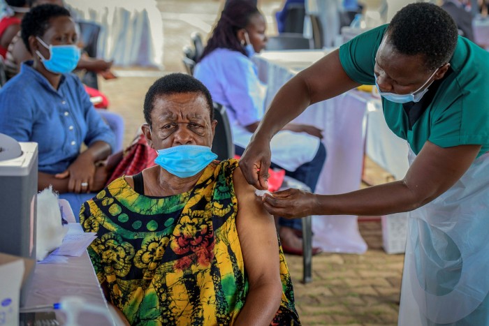 A woman receives a coronavirus vaccination in Kampala, Uganda