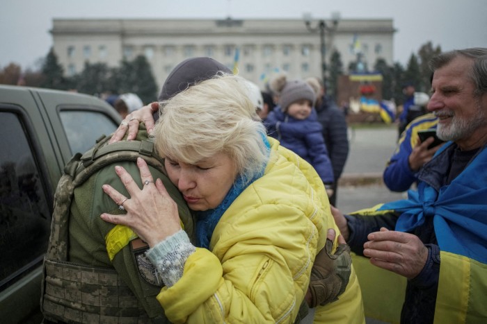 A resident hugs a Ukrainian soldier in central Kherson as the inhabitants celebrate Russia’s retreat from the city